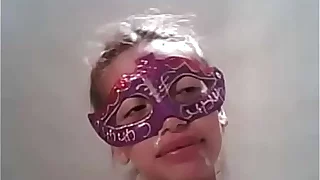 Masked pretty girl gets a cum rain over her face